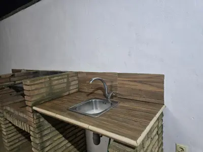 a kitchen sink with a wooden counter top at Sancti Petri in Chiclana de la Frontera