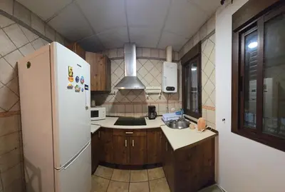 a kitchen with a white refrigerator and a sink at Sancti Petri in Chiclana de la Frontera