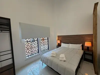 a bedroom with a bed with two towels on it at Apartamento Loft nuevo a 5 min de la playa in Cádiz