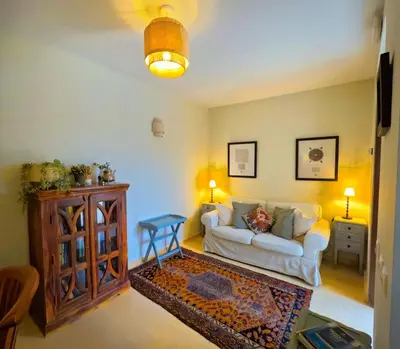 a living room with a white couch and a table at Casa de Medina in Medina Sidonia