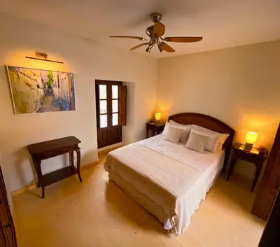 a bedroom with a bed and a ceiling fan at Casa de Medina in Medina Sidonia