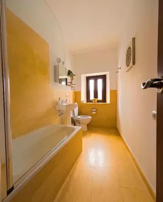 a bathroom with a tub and a toilet and a sink at Casa de Medina in Medina Sidonia