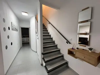 a staircase in a room with white walls at Apartamento chillout centrico in Sanlúcar de Barrameda