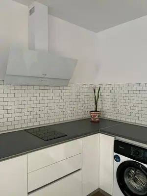 a kitchen with white cabinets and a stove top oven at Preciosa casa Sol y Luna in Chiclana de la Frontera