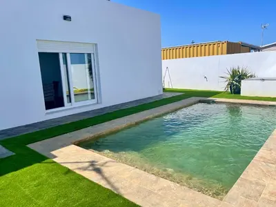 a swimming pool in the backyard of a house at Preciosa casa Sol y Luna in Chiclana de la Frontera