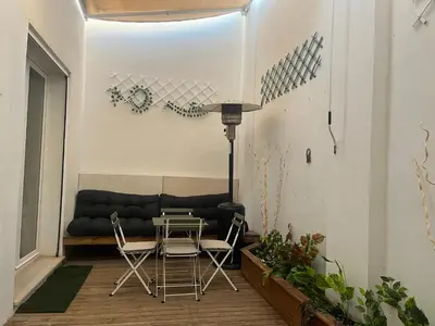 a living room with a couch and a table and chairs at Mi Teja in Chiclana de la Frontera