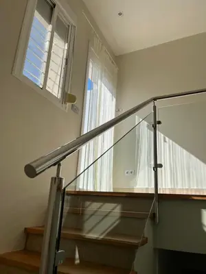 a staircase with a glass railing and a window at Mi Teja in Chiclana de la Frontera