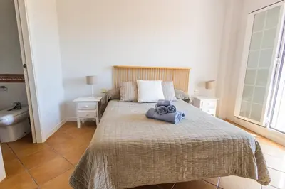 two twin beds in a room with white walls at GuestReady - Cabiedes Marina Golf JC in Rota