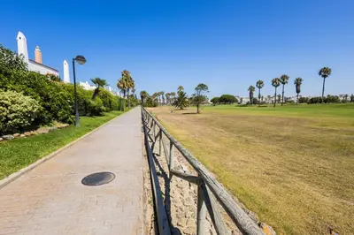 a golf course with a tree in the middle of a green at GuestReady - Cabiedes Marina Golf JC in Rota