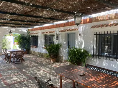 a patio with tables and chairs and a building at Campito cerca del mar 