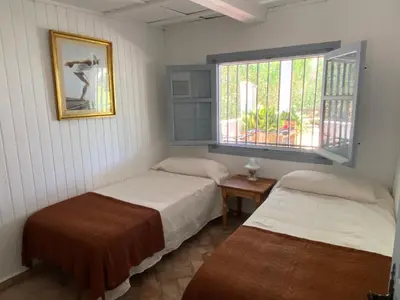 a room with two beds and a window at Campito cerca del mar 