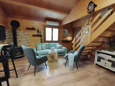 a living room with a couch and chairs and a staircase at Casa Pinares de Roche tres dormitorios in Cádiz