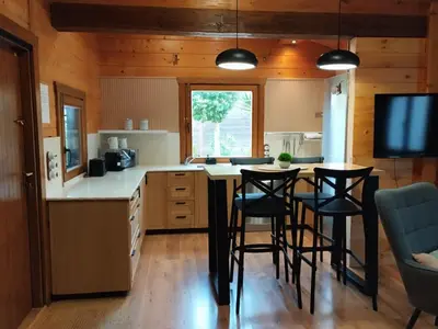 a kitchen with a table and chairs in a room at Casa Pinares de Roche tres dormitorios in Cádiz