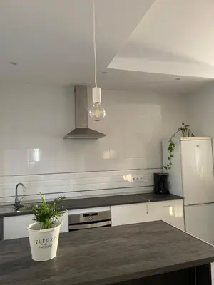 a kitchen with a counter top and a refrigerator at La casa de Cris in Sanlúcar de Barrameda