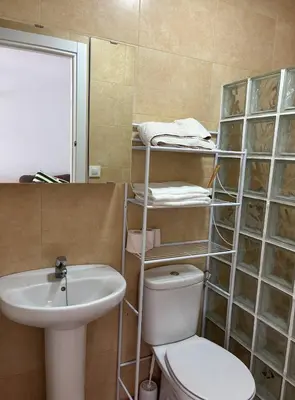 a bathroom with a toilet and a sink and a mirror at Villa con piscina in Chiclana de la Frontera