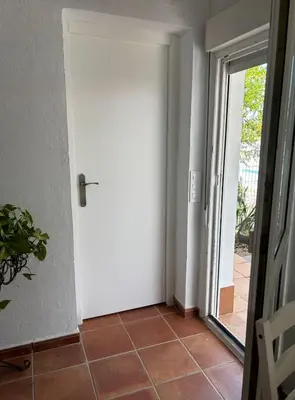 a door leading into a room with a tile floor at Villa con piscina in Chiclana de la Frontera