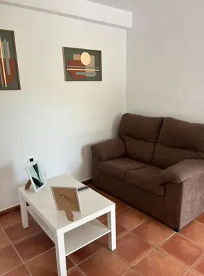 a living room with a couch and a coffee table at Villa con piscina in Chiclana de la Frontera