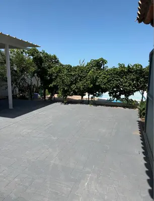 a large parking lot with trees in the background at Villa con piscina in Chiclana de la Frontera