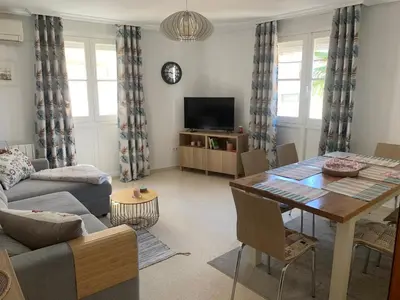 a living room with a table and a couch at Casa Calle Merced in Cádiz