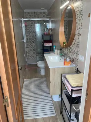a bathroom with a sink and a toilet and a mirror at Casa Calle Merced in Cádiz
