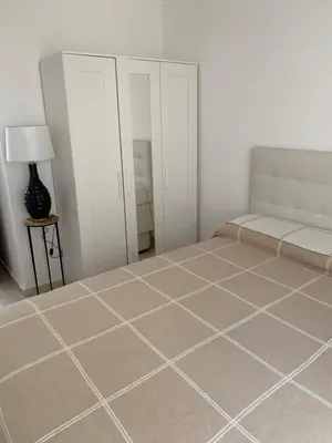 a bedroom with a bed and a tiled floor at Casa Calle Merced in Cádiz