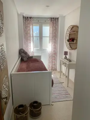 a bedroom with a bed and a window and a desk at Casa Calle Merced in Cádiz