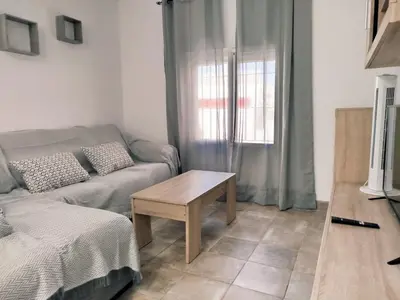 a living room with a couch and a table at Casa Chiclana Centro in Chiclana de la Frontera