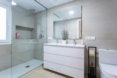 a white bathroom with a sink and a shower at Plaza Caballo 3 Dormitorios Vistas in Jerez de la Frontera