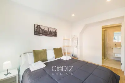 a white bathroom with a sink and a mirror at AVENTURERO Apartment by Cadiz4Rentals in Cádiz