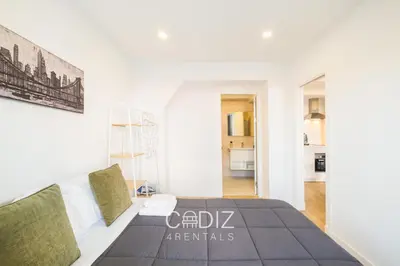 a living room with a blue couch in a room at AVENTURERO Apartment by Cadiz4Rentals in Cádiz