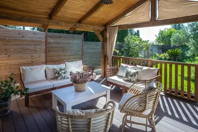 a patio with a couch and chairs on a deck at casa Villa Escondida in Cádiz