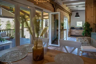 a dining room with a table with a vase at casa Villa Escondida in Cádiz