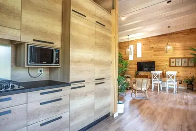 a kitchen with wooden walls and a dining room at casa Villa Escondida in Cádiz