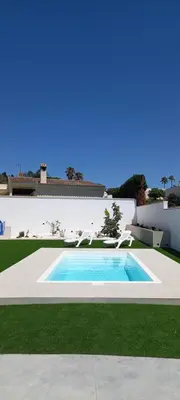 a swimming pool in the yard of a house at Casa Lili in Conil de la Frontera