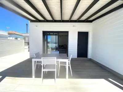 a table and chairs on the patio of a house at Casa Lili in Conil de la Frontera