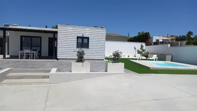 a house with a patio and a swimming pool at Casa Lili in Conil de la Frontera