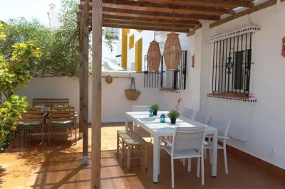 a white table and chairs on a patio at Estupendo adosado en La Barrosa, a 700 m de la Playa in Chiclana de la Frontera