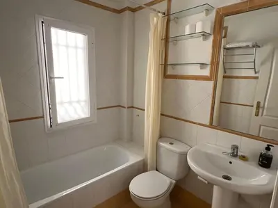 a bathroom with a toilet and a tub and a sink at GINVA - Dúplex en Plaza de España in El Puerto de Santa María