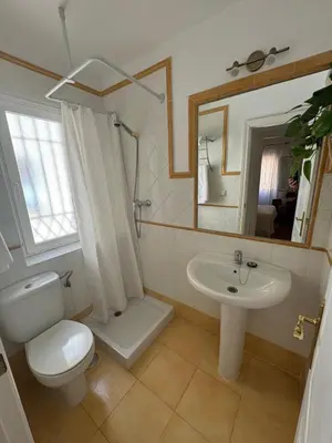 a bathroom with a toilet and a sink and a mirror at GINVA - Dúplex en Plaza de España in El Puerto de Santa María