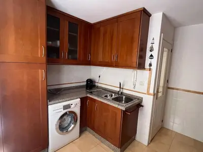 a small kitchen with a sink and a washing machine at GINVA - Dúplex en Plaza de España in El Puerto de Santa María