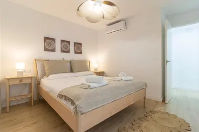a bedroom with a bed with two towels on it at Allo Apartments Morenos II 1ºC Centro 2 Habitaciones in Jerez de la Frontera