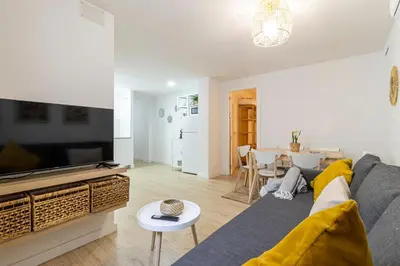 a living room with a blue couch and a television at Allo Apartments Morenos II 1ºC Centro 2 Habitaciones in Jerez de la Frontera
