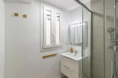 a white bathroom with a sink and a shower at Allo Apartments Morenos III Bajo A Centro 2 Habitaciones in Jerez de la Frontera