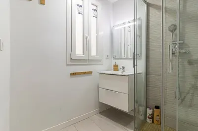 a white bathroom with a sink and a shower at Allo Apartments Morenos III Bajo A Centro 2 Habitaciones in Jerez de la Frontera