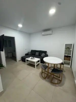 a living room with a couch and a table at Apartamento El Oasis in Chiclana de la Frontera