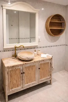 a bathroom with a wooden sink and a mirror at Mirando al Mar con Wifi y Terraza 1ª línea playa in Cádiz