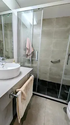a bathroom with a glass shower and a sink at Rincón del Atlántico in Rota