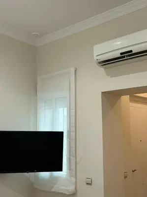 a flat screen tv in a room with a window at Apartamento en el centro histórico in El Puerto de Santa María