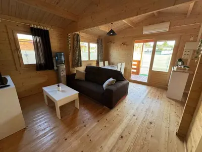 a living room with a couch and a table at Bungalow Sol in Chiclana de la Frontera