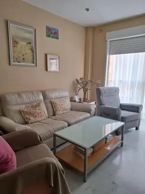 a living room with a couch and a coffee table at Apartamento céntrico con garaje opcional in Sanlúcar de Barrameda